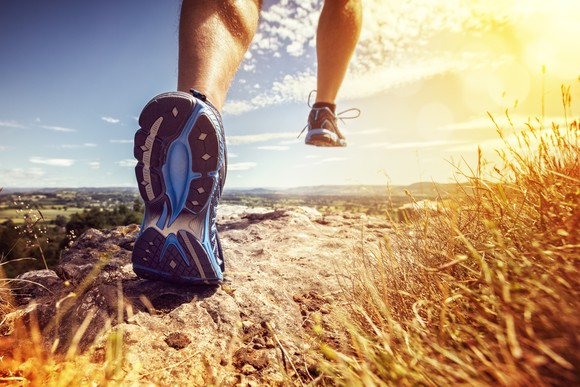 A jogger runs a hiking trail.