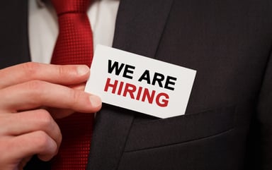 Businessman with we are hiring card
