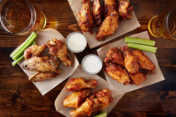 Four plates of chicken wings.