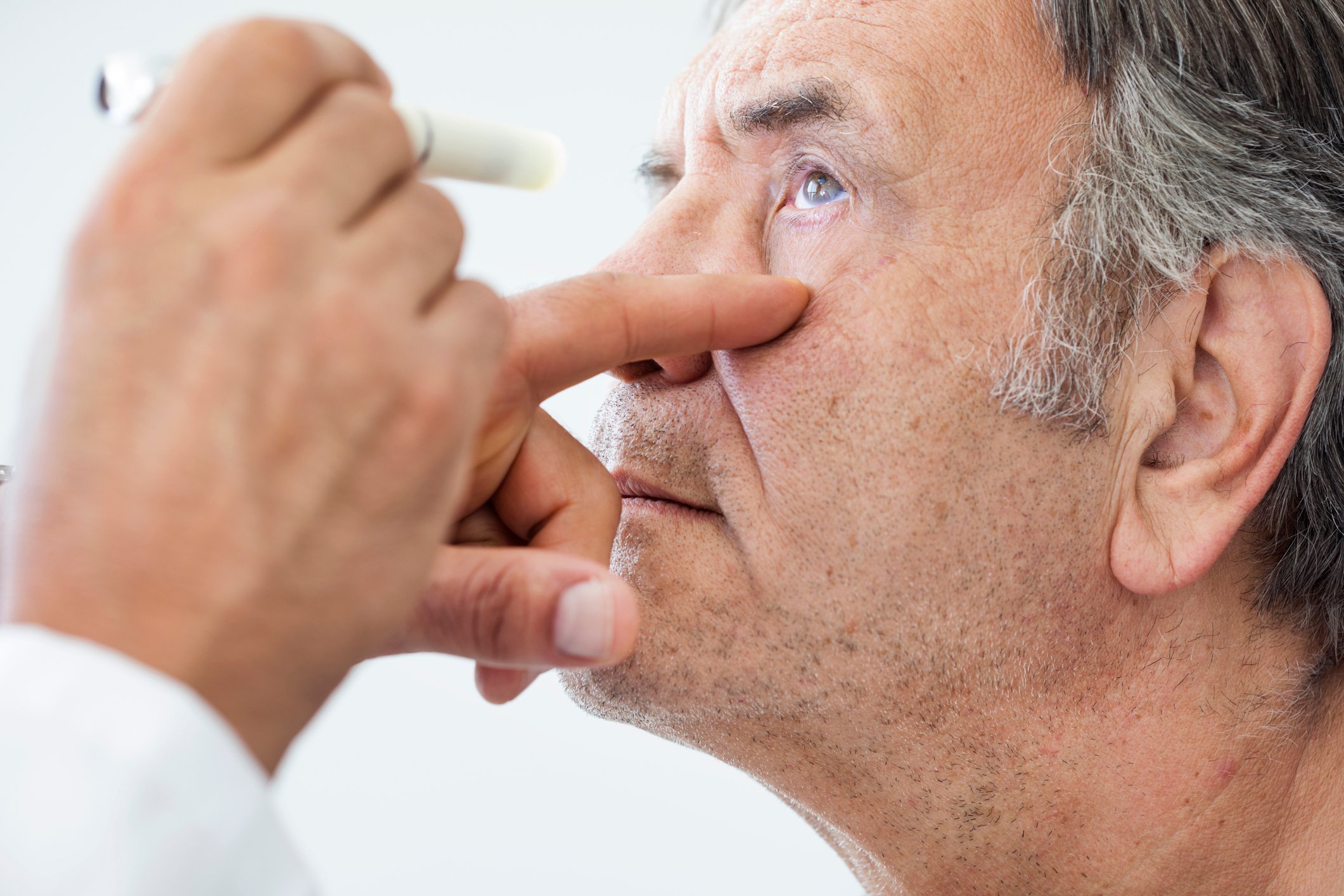 An elderly man undergoing an eye exam.