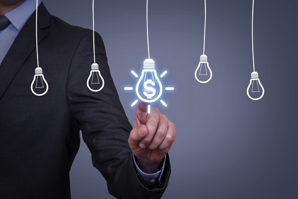 A man touching an idea bulb on a virtual screen.