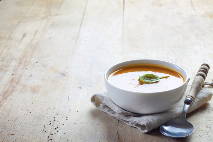 A bowl of soup on a table.