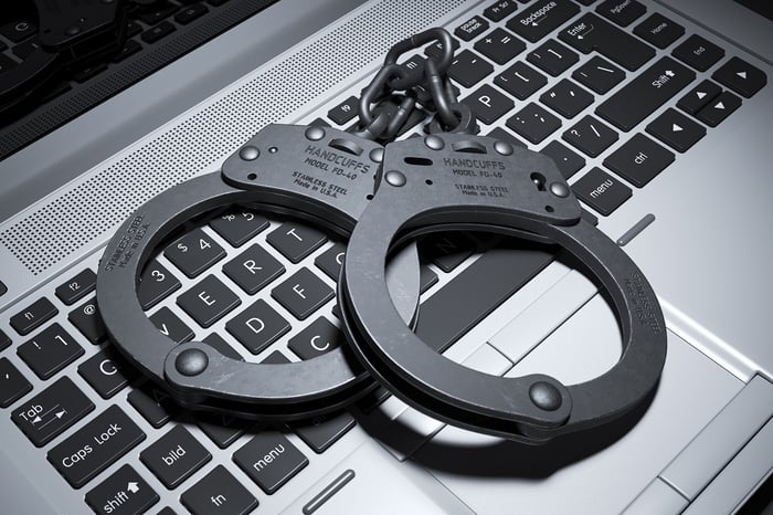 Black handcuffs on a laptop keyboard.