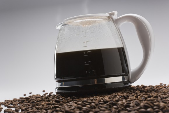 Coffee pot on pile of coffee beans