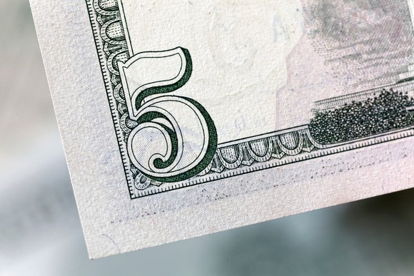 Corner of a five dollar bill.