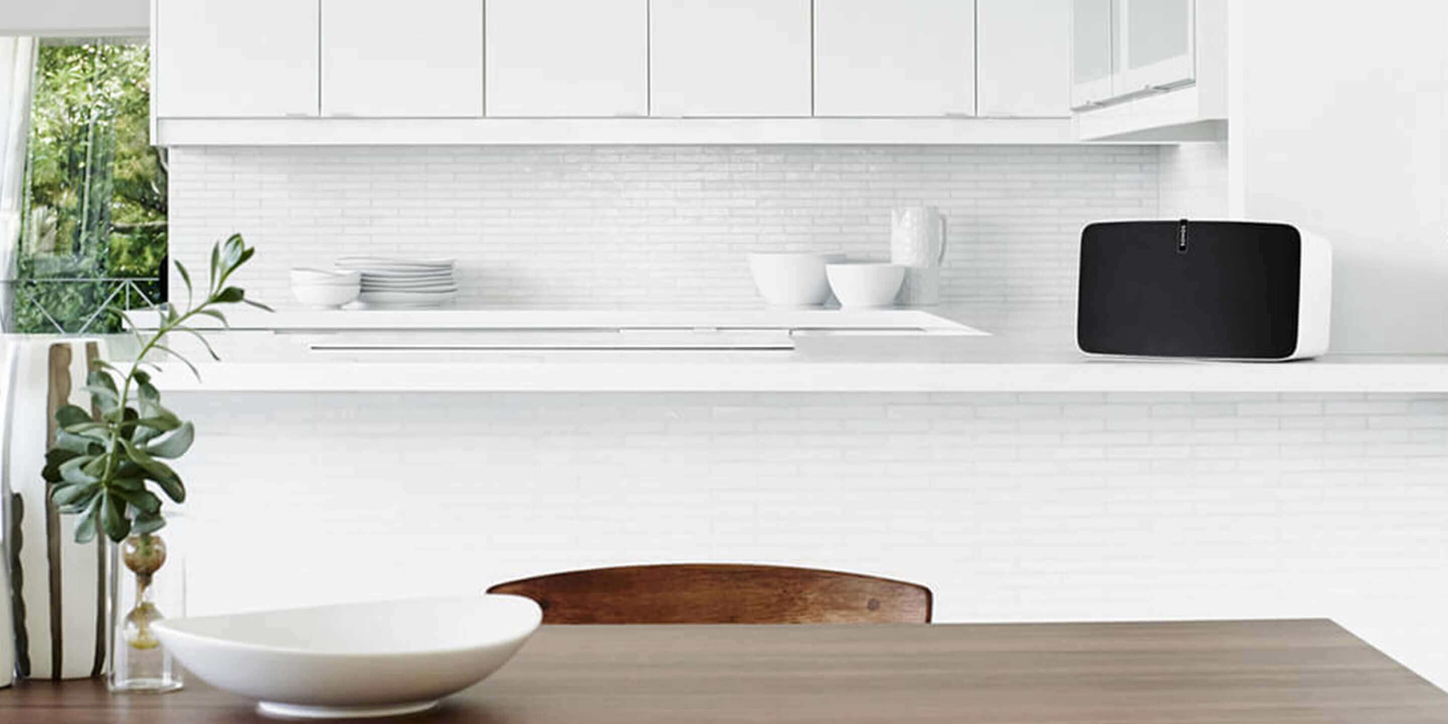 Sonos wireless speaker in a mostly white kitchen.