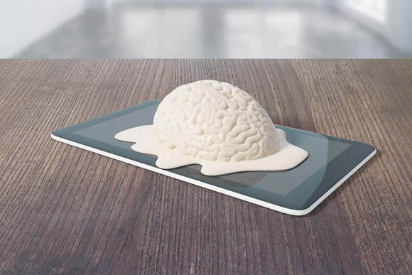 A plastic brain melting on top of a smartphone.