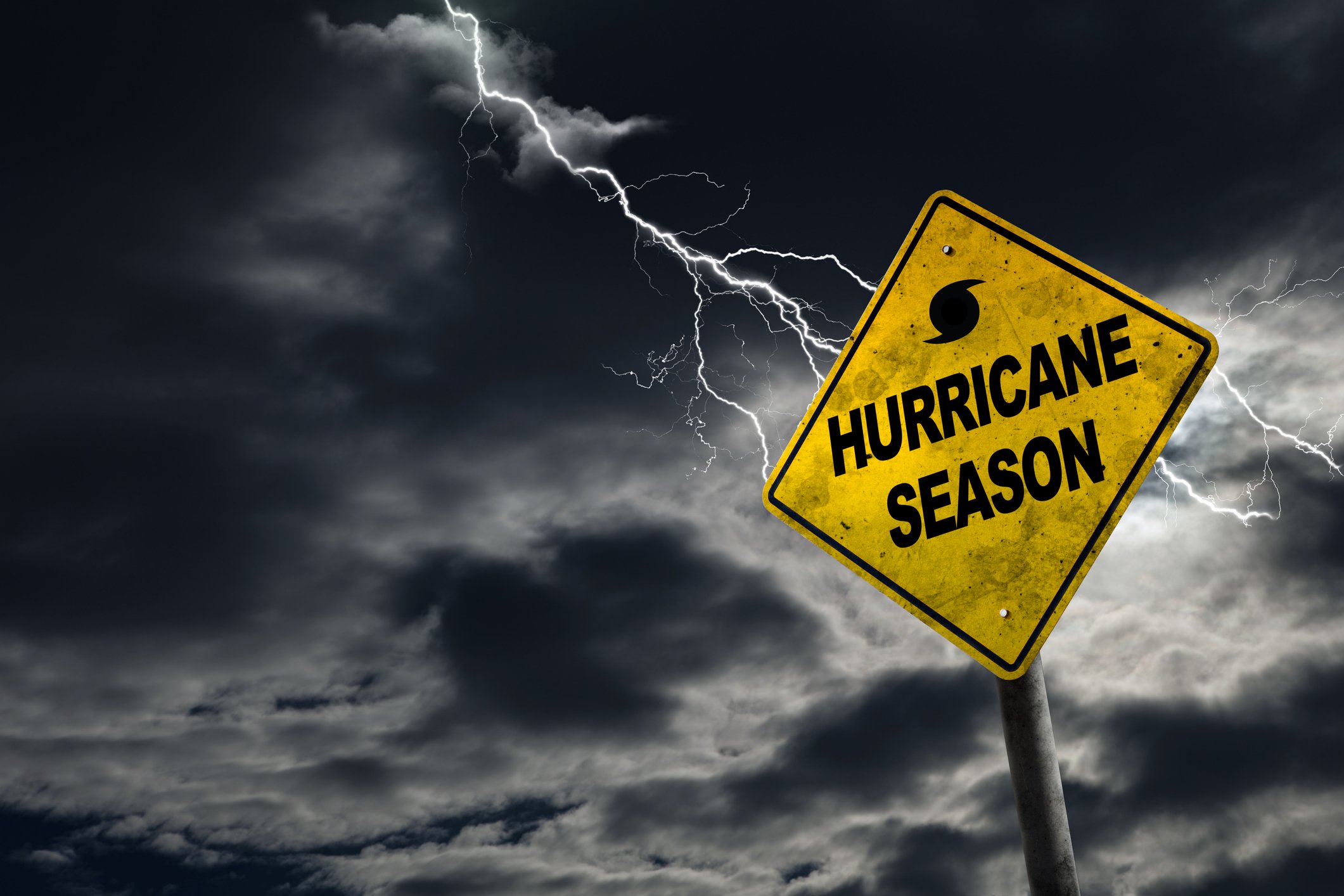 An illustration shows a hurricane and a sign saying hurricane season.