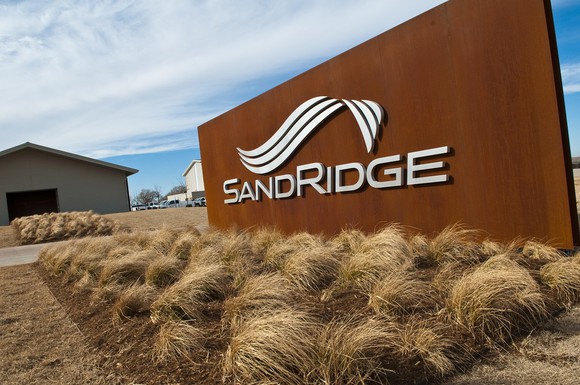 SandRidge logo on a sign in front of a building facility.