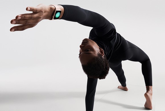 A person doing yoga with an Apple Watch