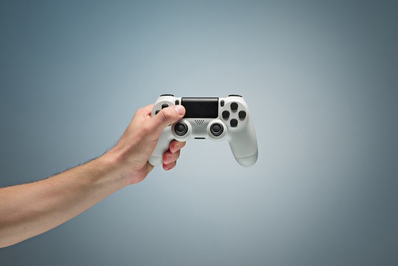 Person holding a gaming controller.
