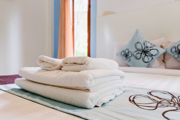 Towels folded neatly on a bed