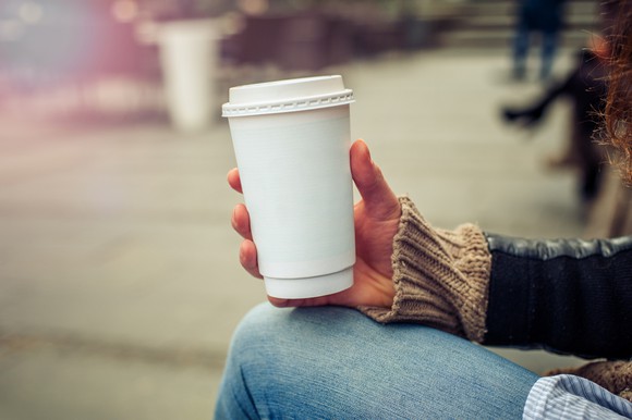 Woman holding a to-go cup