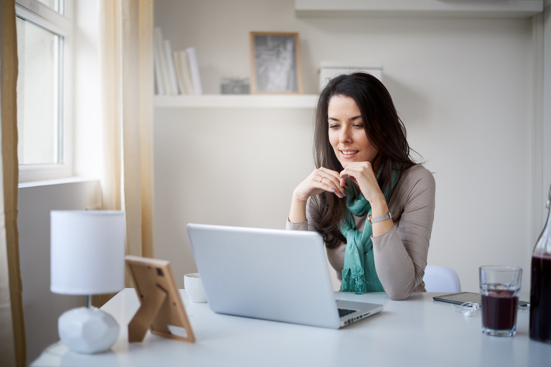Woman at laptop in what appears to be a home setting
