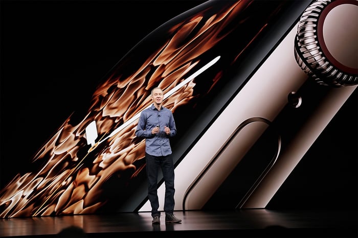 Apple COO Jeff Williams on stage in front of an image of the Apple Watch Series 4.