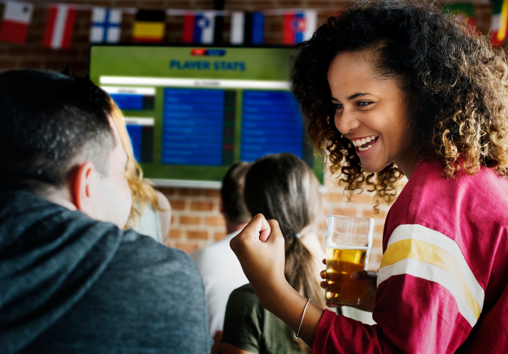 Friends cheering together at a sports bar