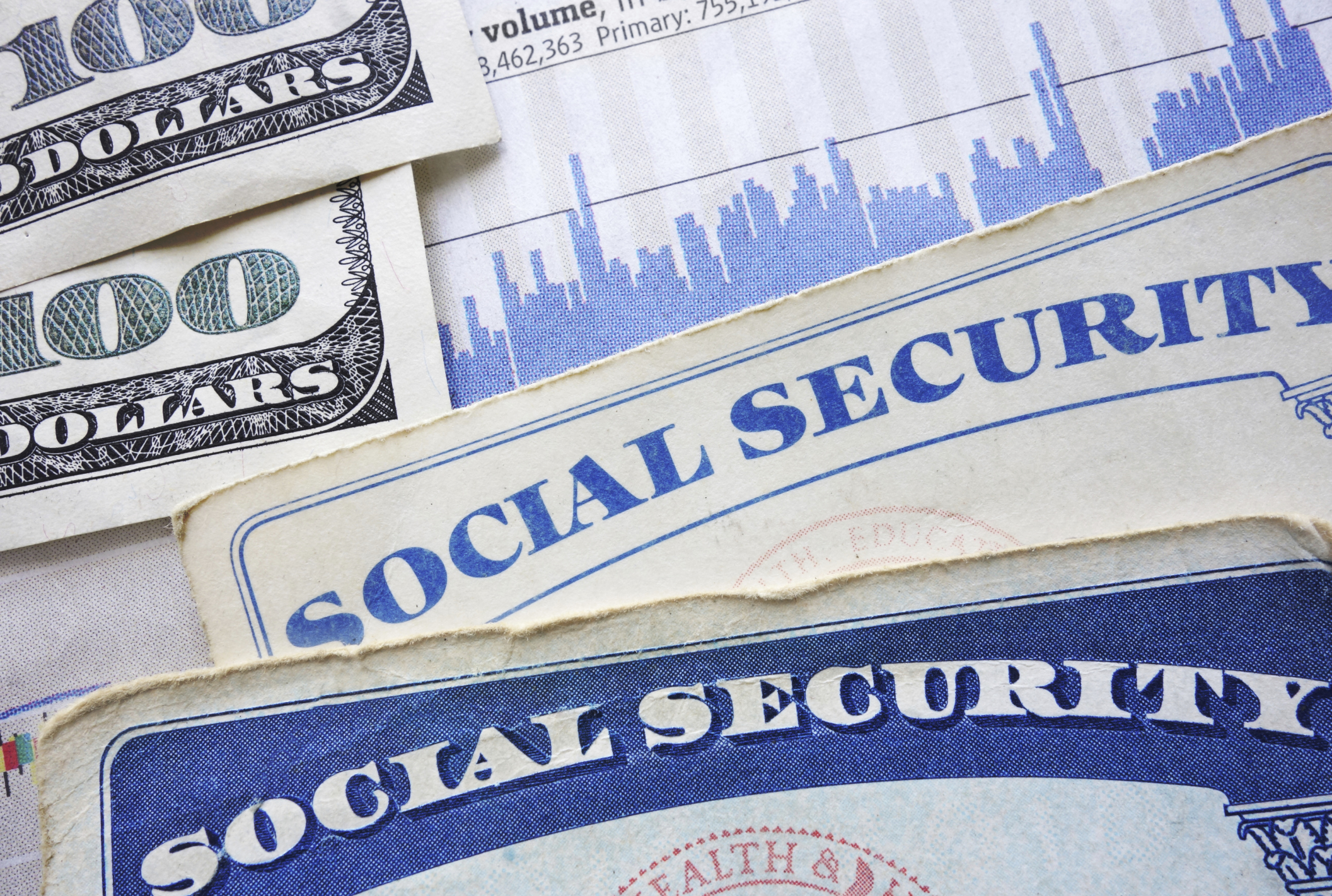 Several Social Security cards and hundred-dollar bills.