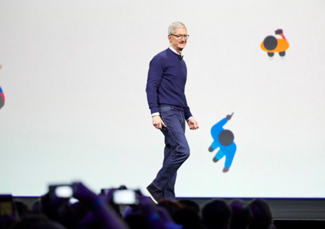 Apple CEO Tim Cook stands on stage at an Apple event. 