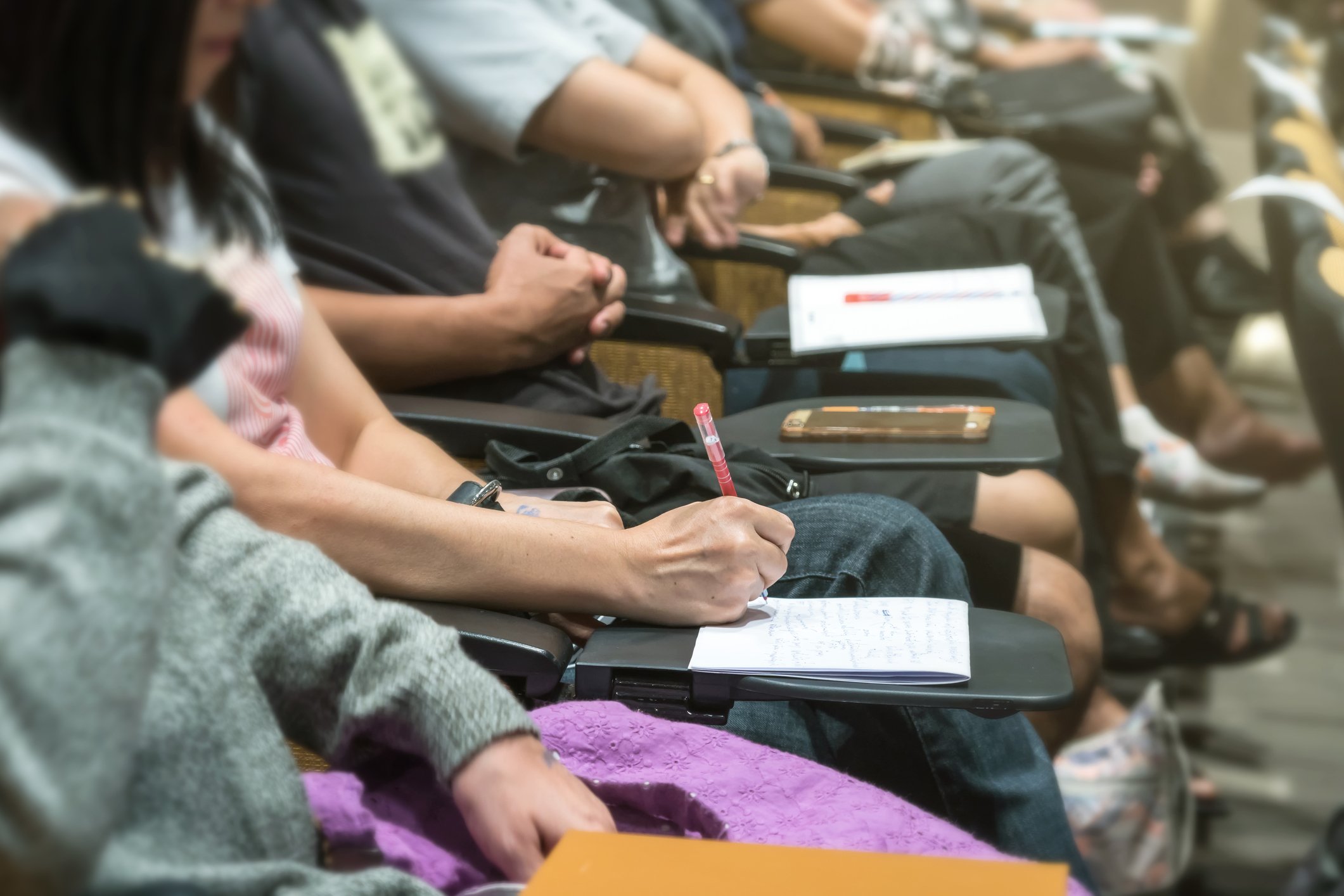 Woman taking notes at a meeting.