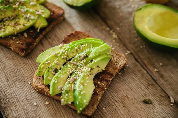 Avocado toast on a wooden table.