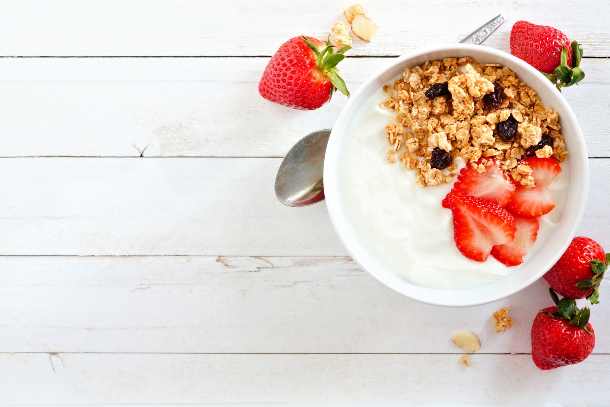 Yogurt with granola and strawberries in a bowl. 