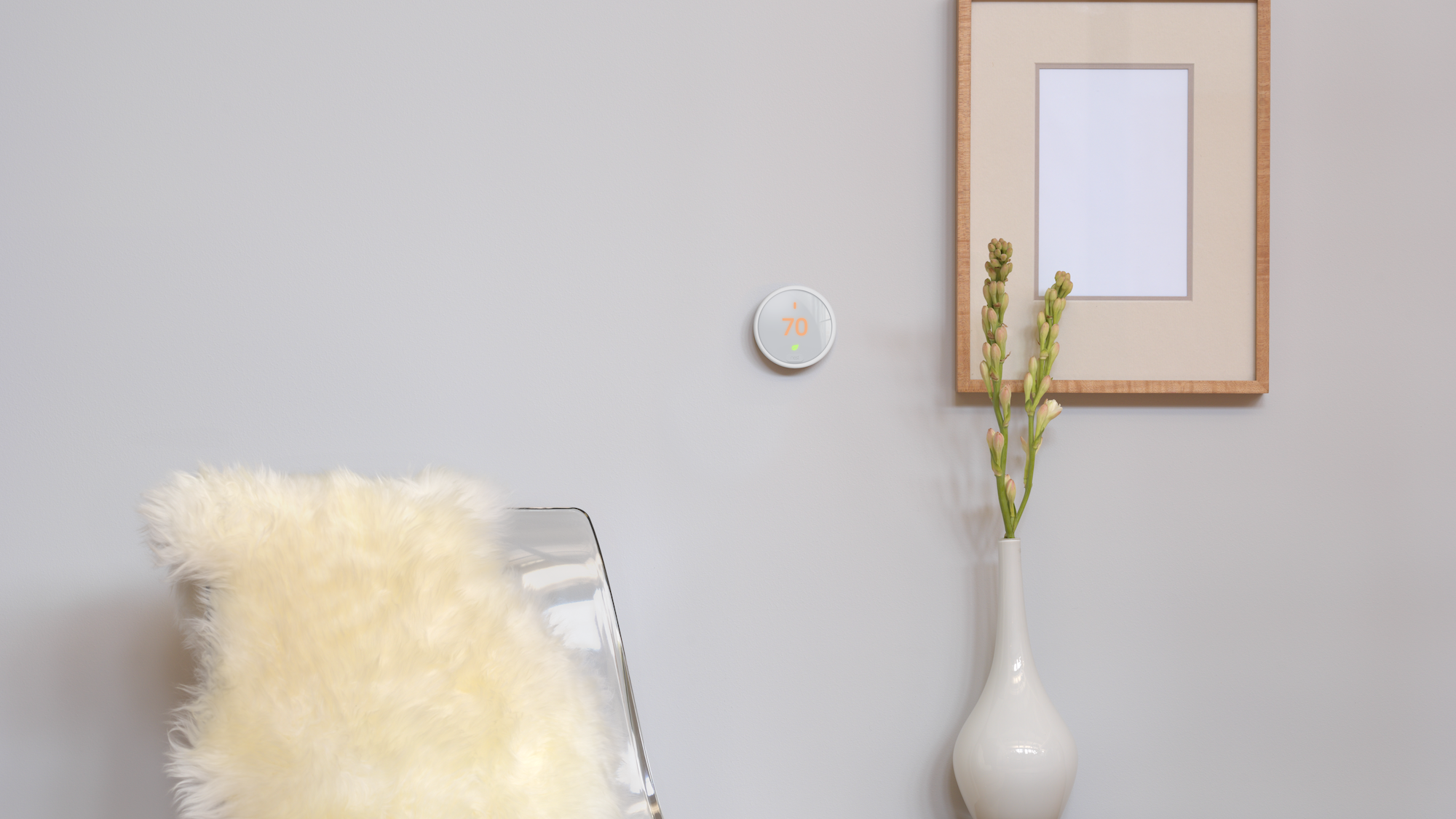 Nest smart thermostat on a wall