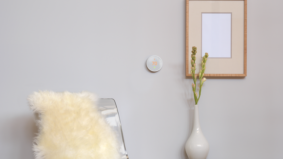 Nest smart thermostat on a wall