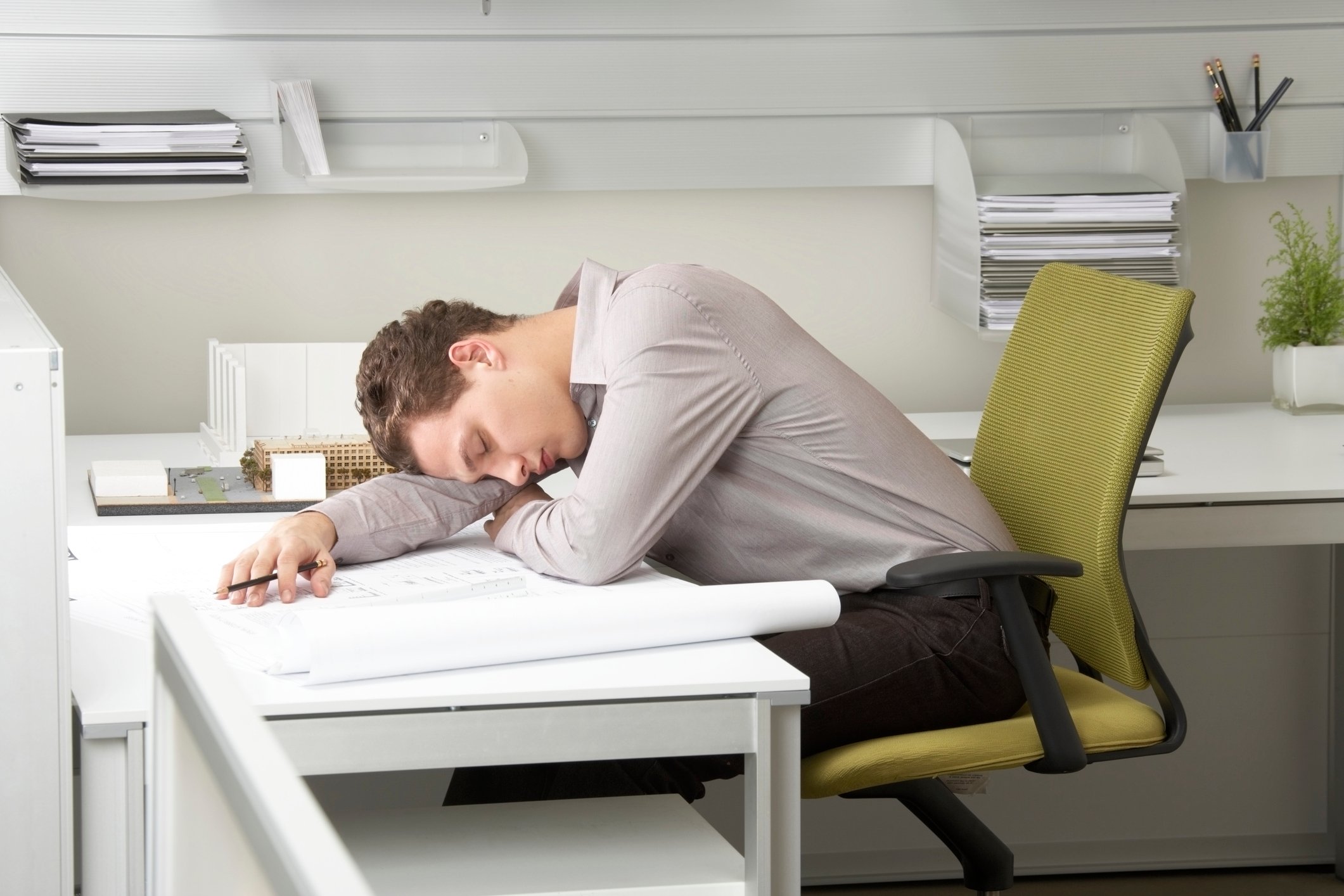 Man sleeping at desk.