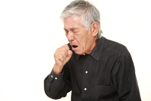Older man coughing