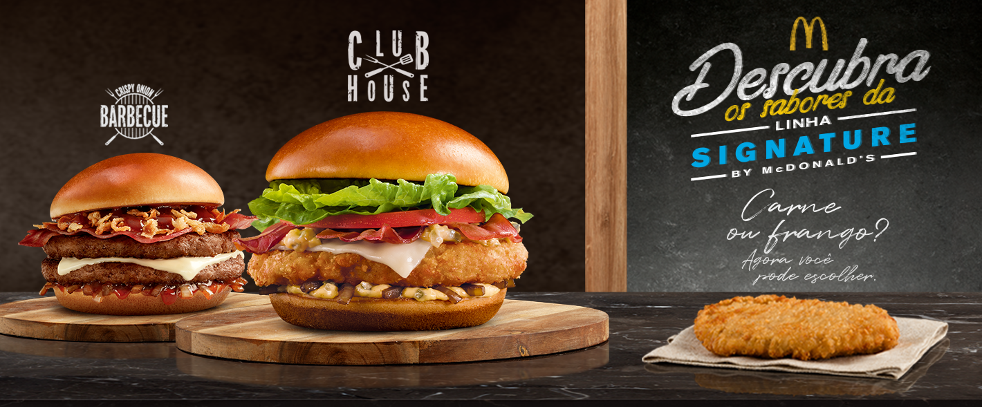 Two premium sandwiches on a chopping board.