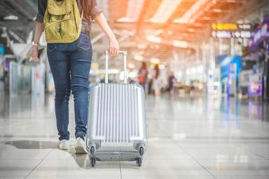 Woman Pulling Suitcase in Airport