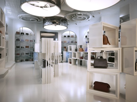 Luxury handbag store with shelves and products on display.