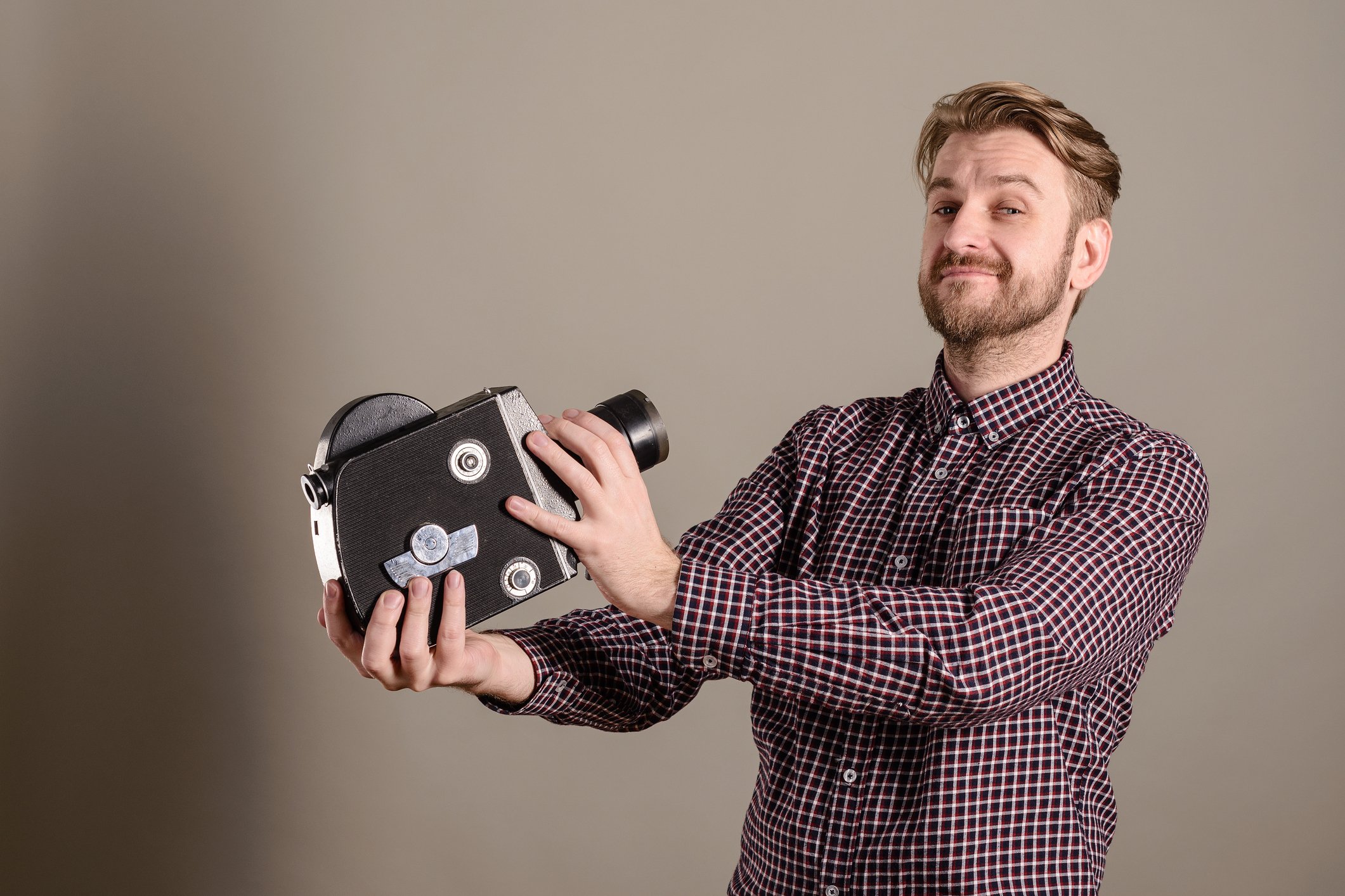Man pointing movie camera at self