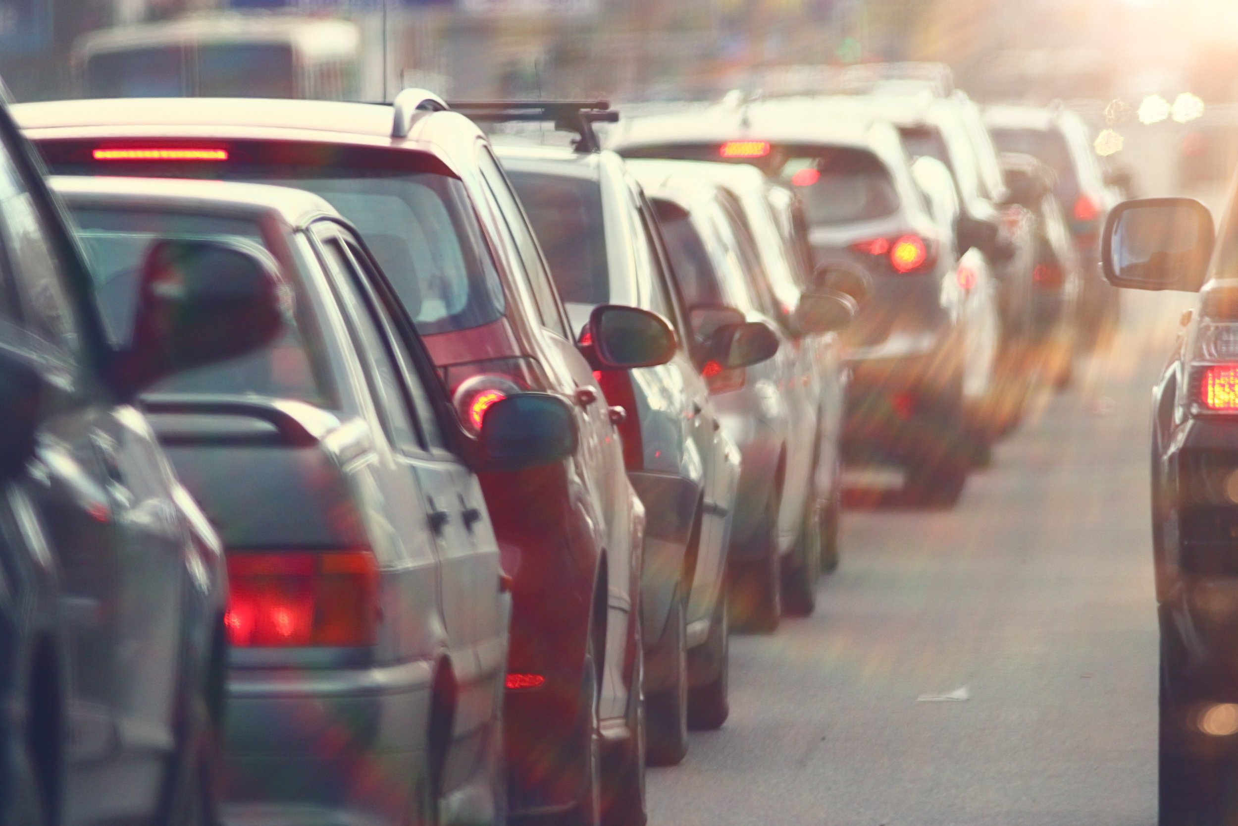 Cars are lined up in bumper-to-bumper traffic.