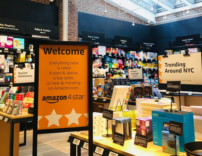 Interior of an Amazon store with a sign indicating that everything in the store is rated 4 stars or higher, a top seller, or trending on Amazon.com.