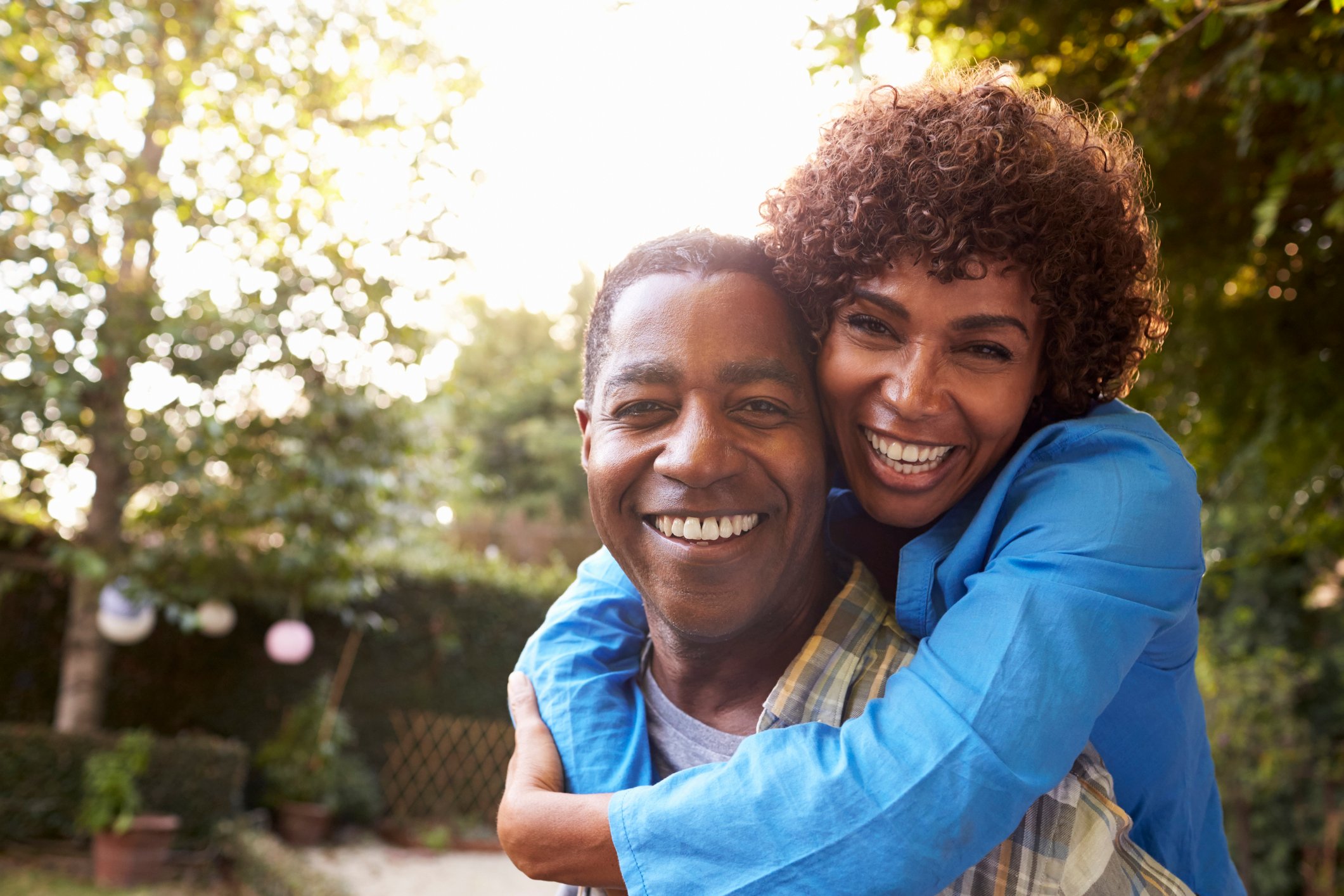 Mature couple hugging and smiling in backyard