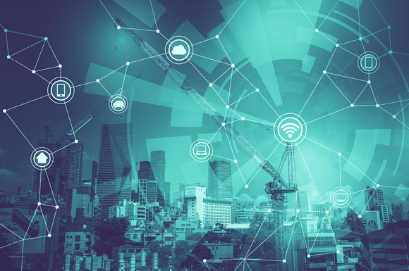 An illustration of a city skyline getting hooked up to the internet through various devices and sensors on buildings and equipment.