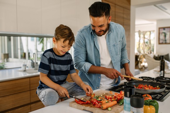 A father and son cooking together.