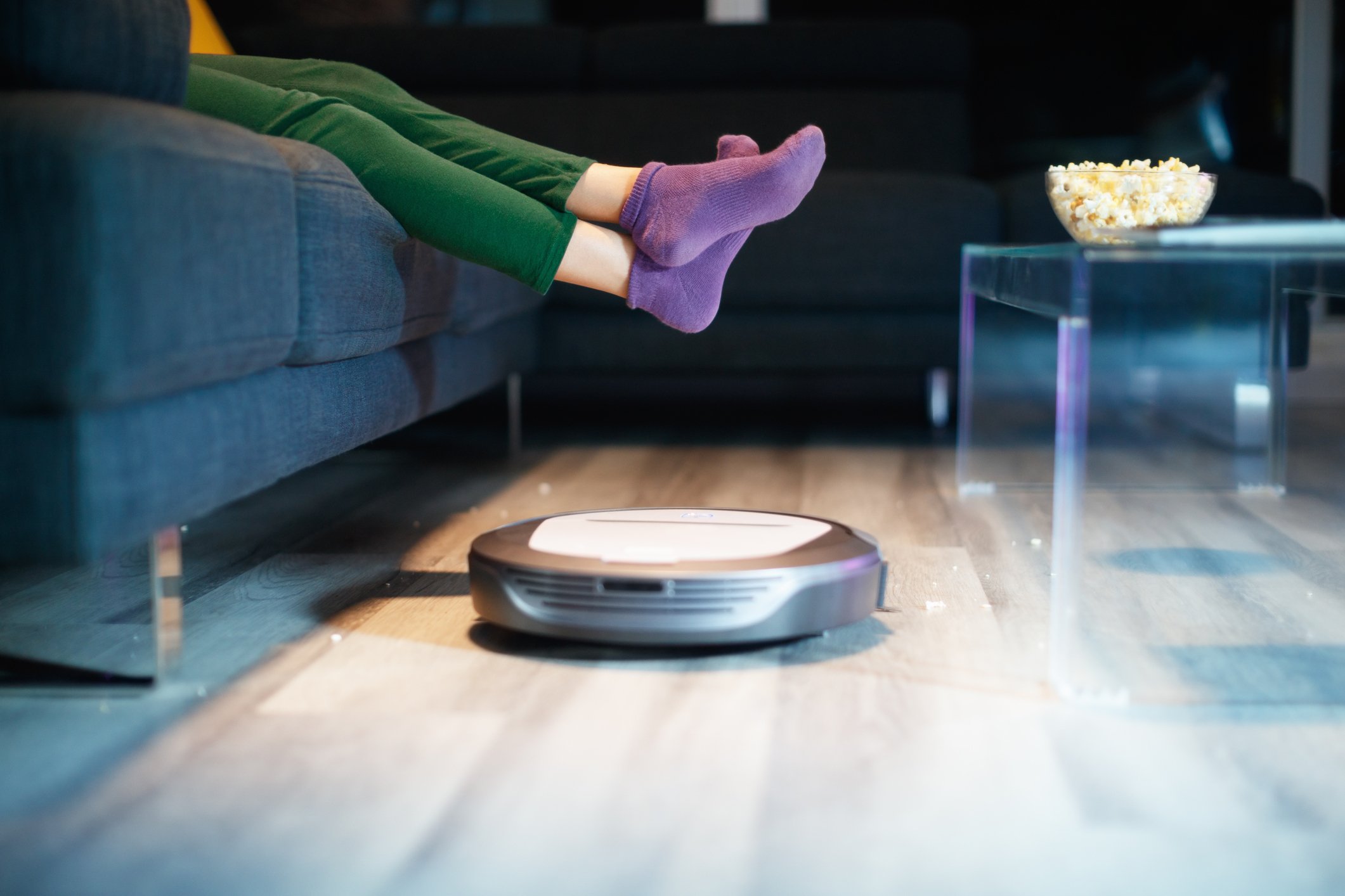 A robotic vacuum cleaner sweeps the floor.