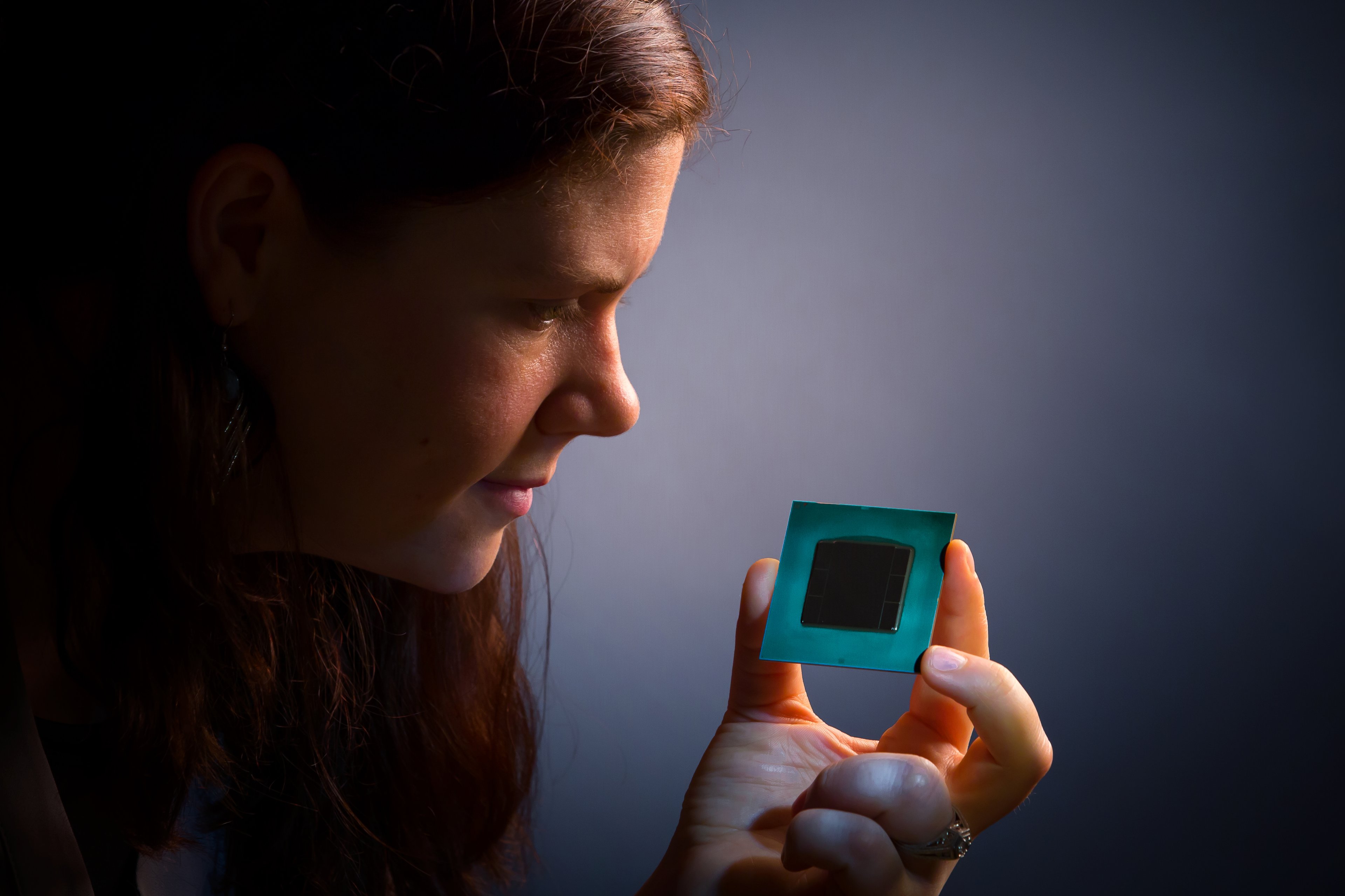 Woman holding a computer chip.