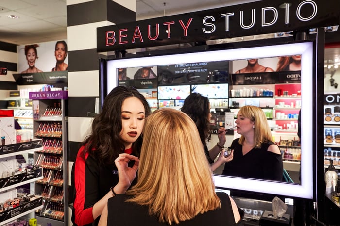 A woman having makeup applied by another woman at a Sephora salon inside a J.C. Penney.