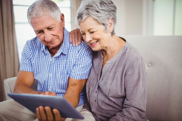 Senior couple looking at an electronic tablet.