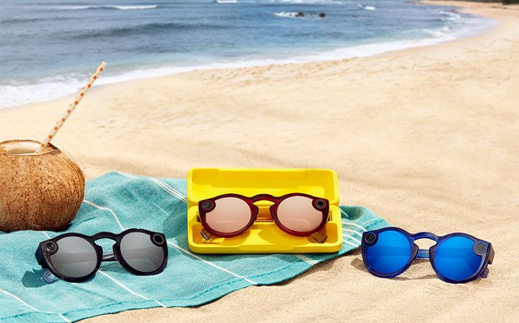 Three pairs of Spectacles 2 on a beach towel on a beach