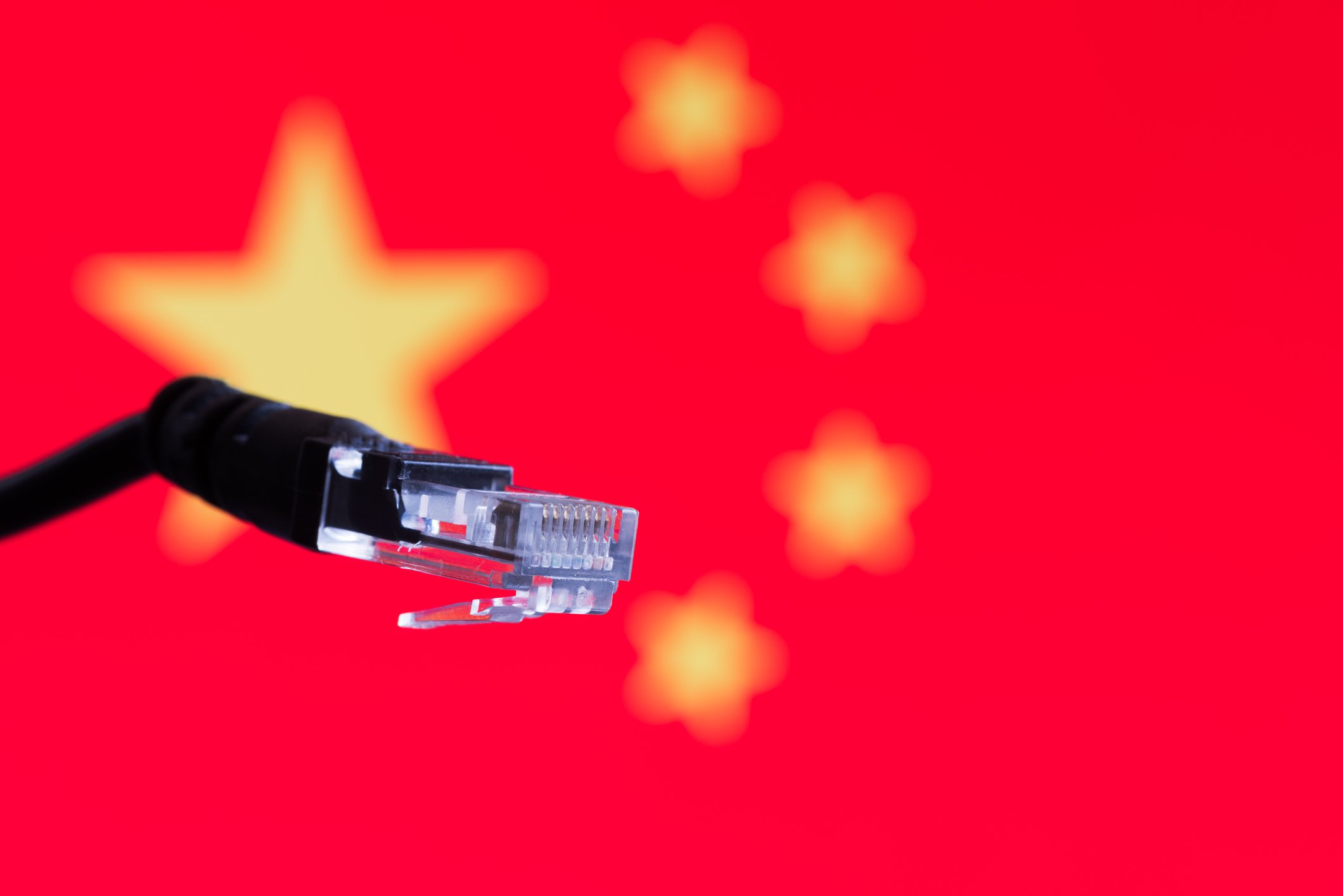 A disconnected network cable with a Chinese flag in the background.