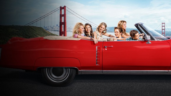 The cast of Fuller House in a convertible driving through San Francisco.