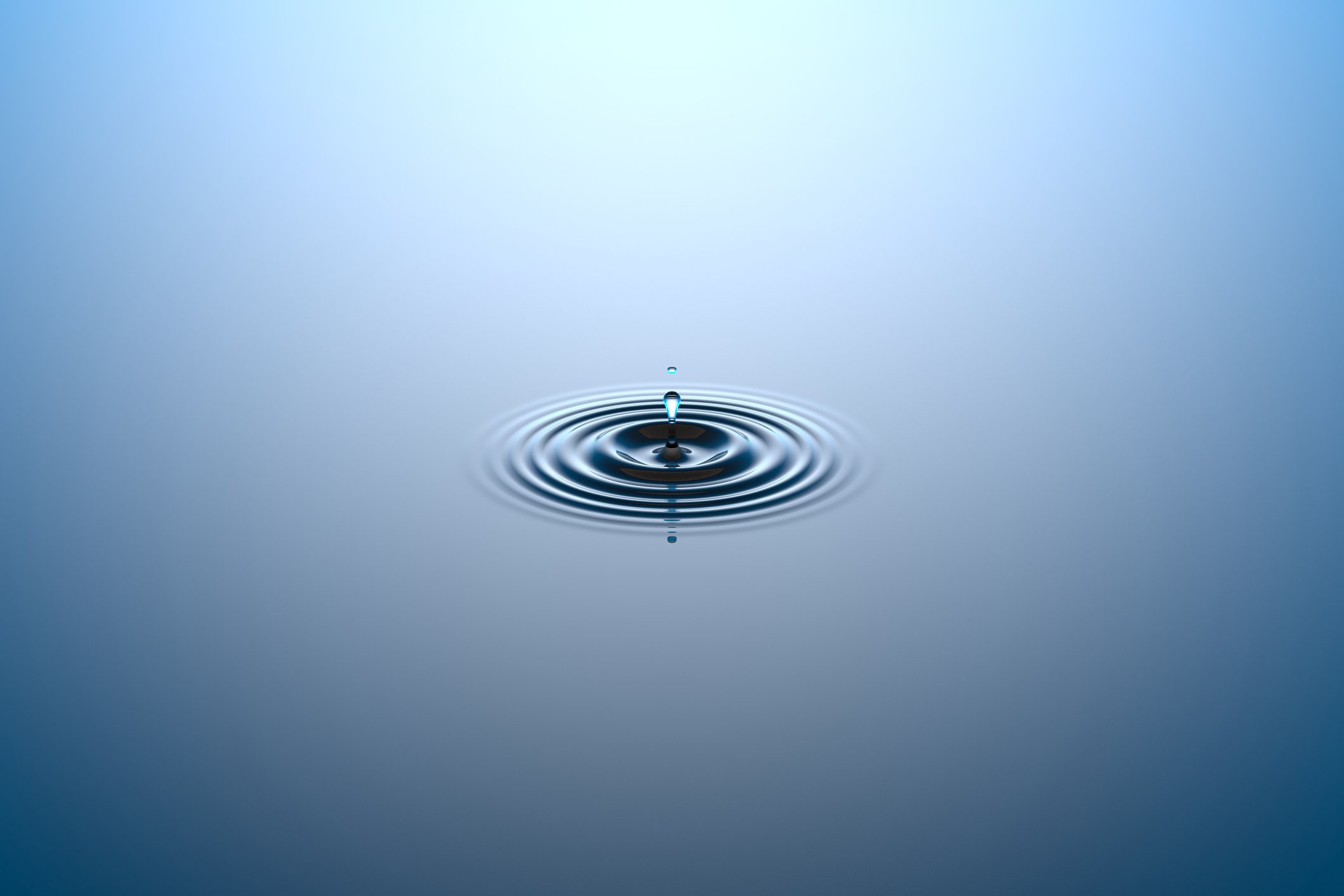 Water dropping onto a water surface.
