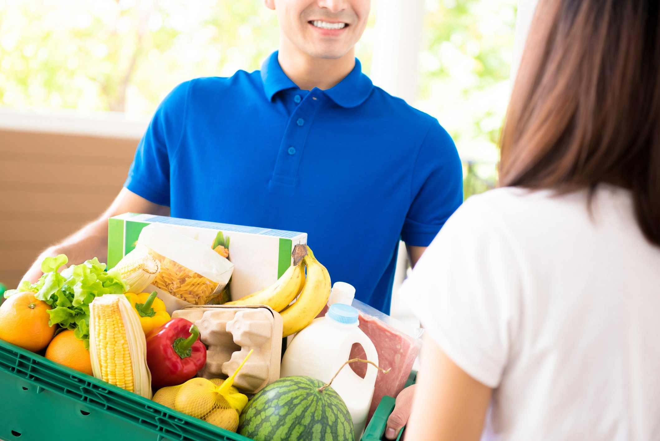 Man delivering groceries to woman