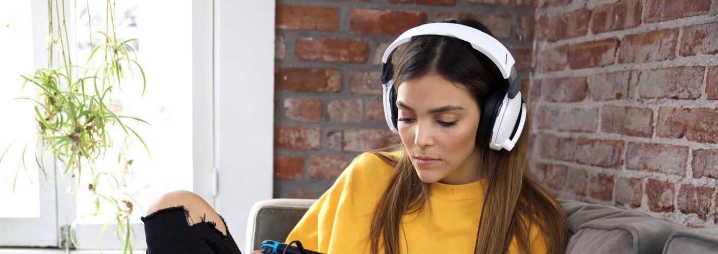 A woman wears a Turtle Beach headset.