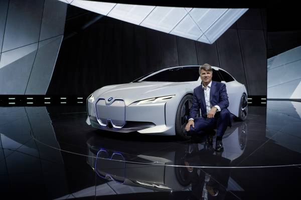 Krueger is shown on an auto-show stand with BMW's i Vision Dynamics concept car, a preview of an electric BMW sedan expected in 2021. 