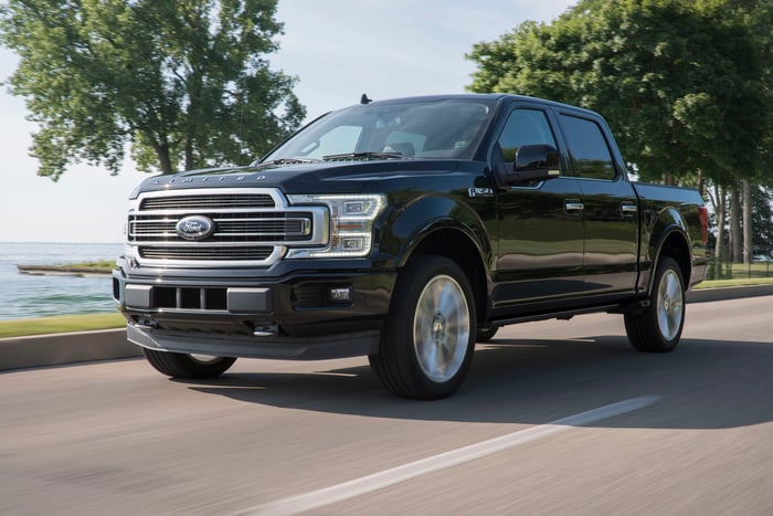 A Ford F-150 Limited 2019 black on a coastal road.